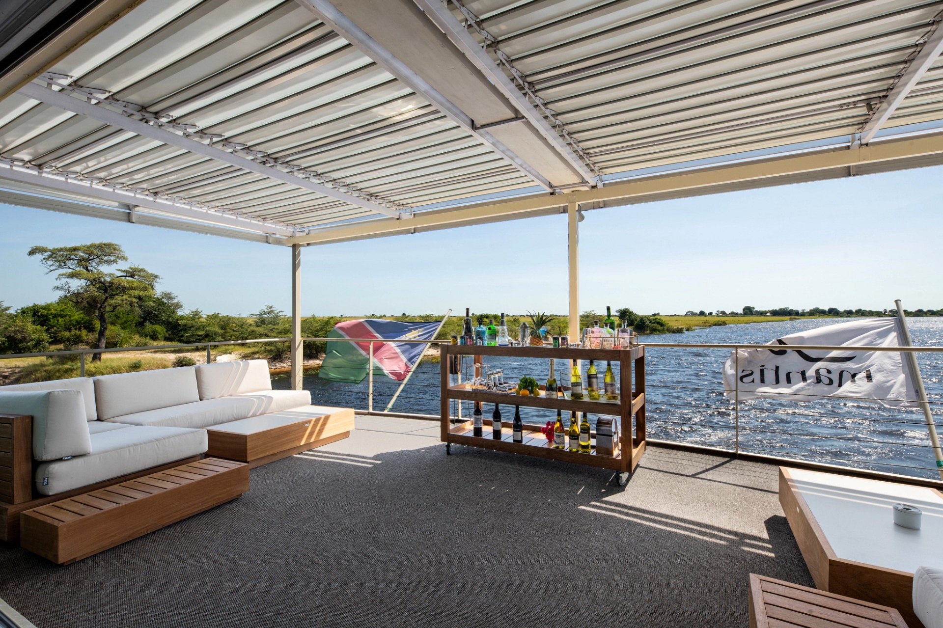 Open-air stern lounge and bar cart on the top deck