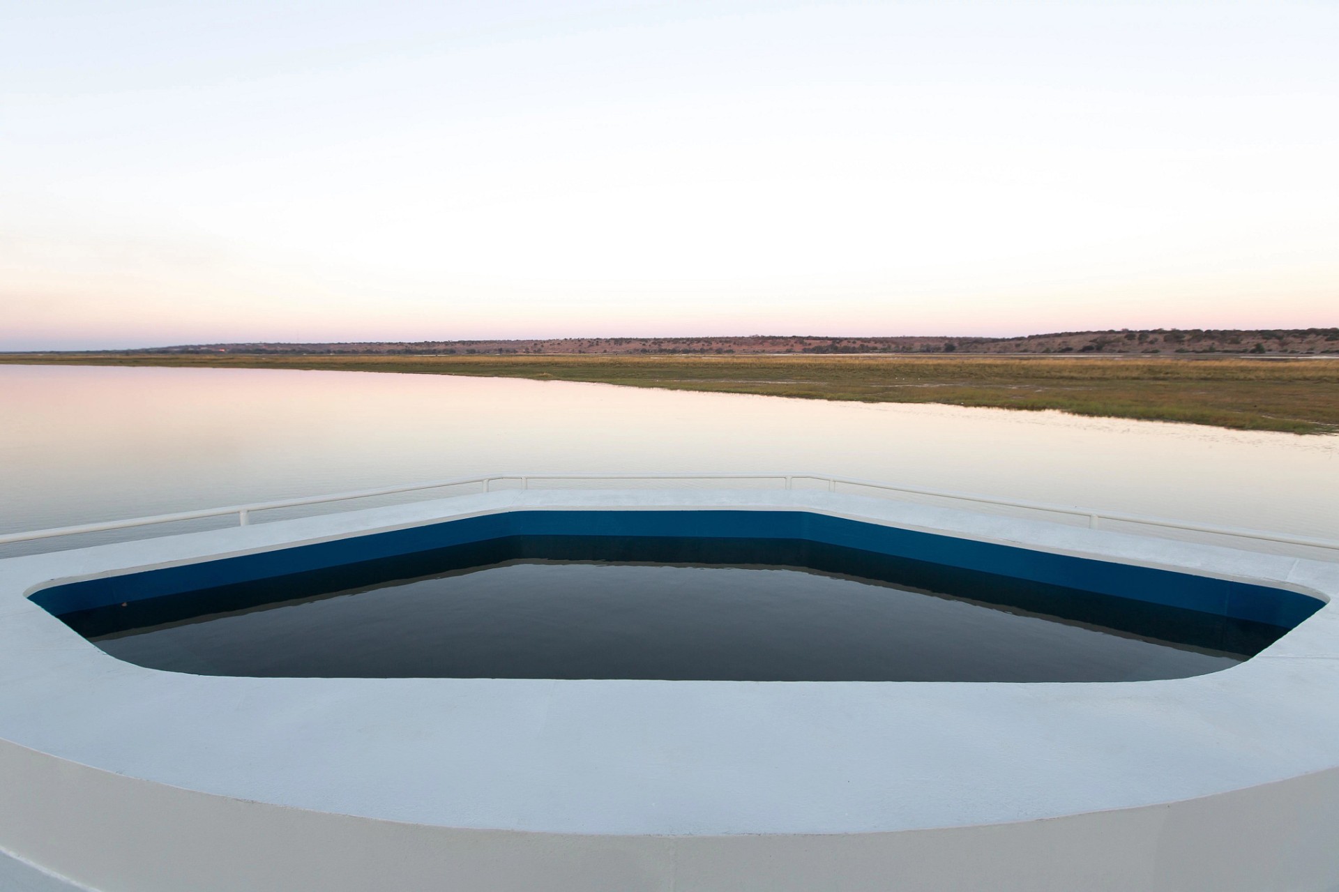 Top-deck plunge pool at dusk on the Chobe River