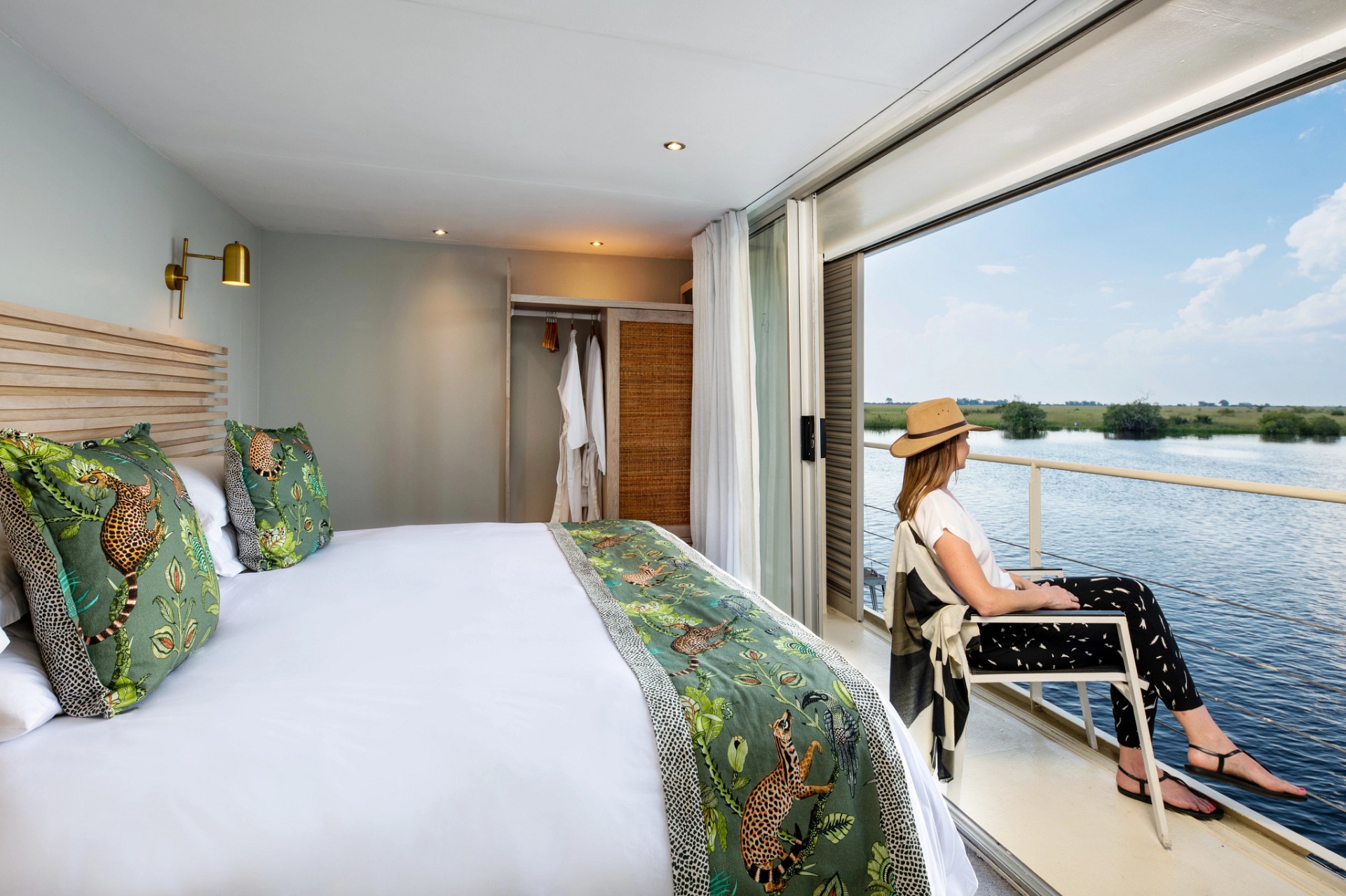 Stateroom with king bed opening to a private balcony over the Chobe